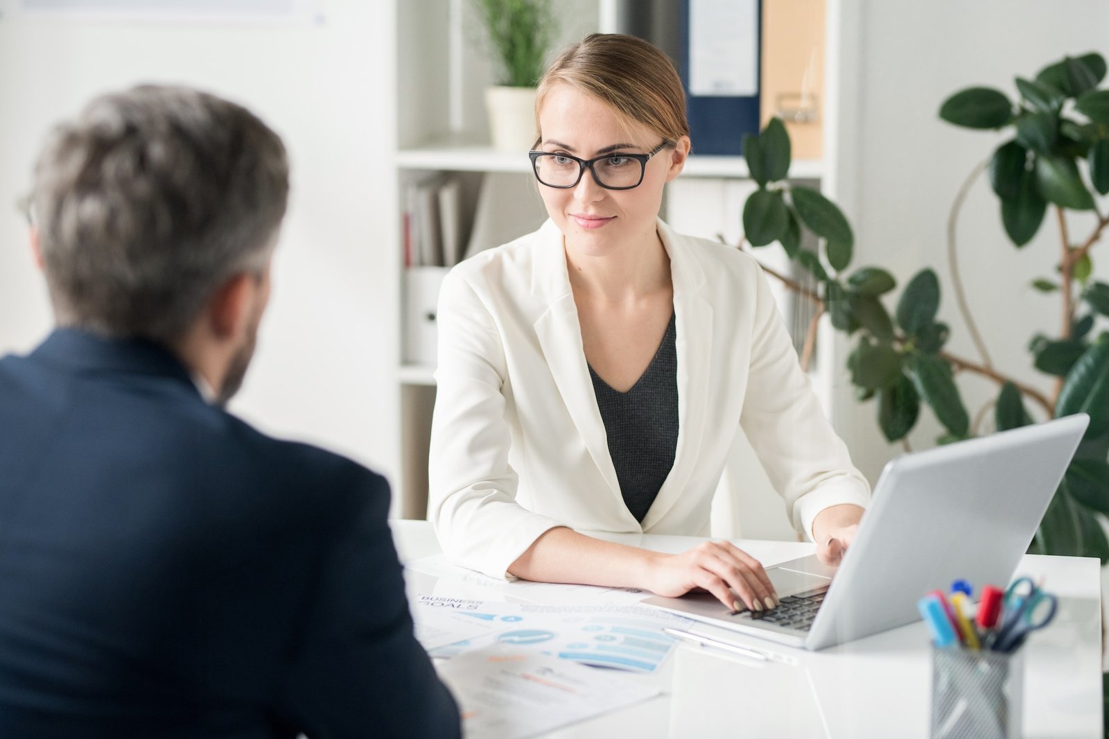 content-attractive-female-business-consultant-working-with-clien.jpg